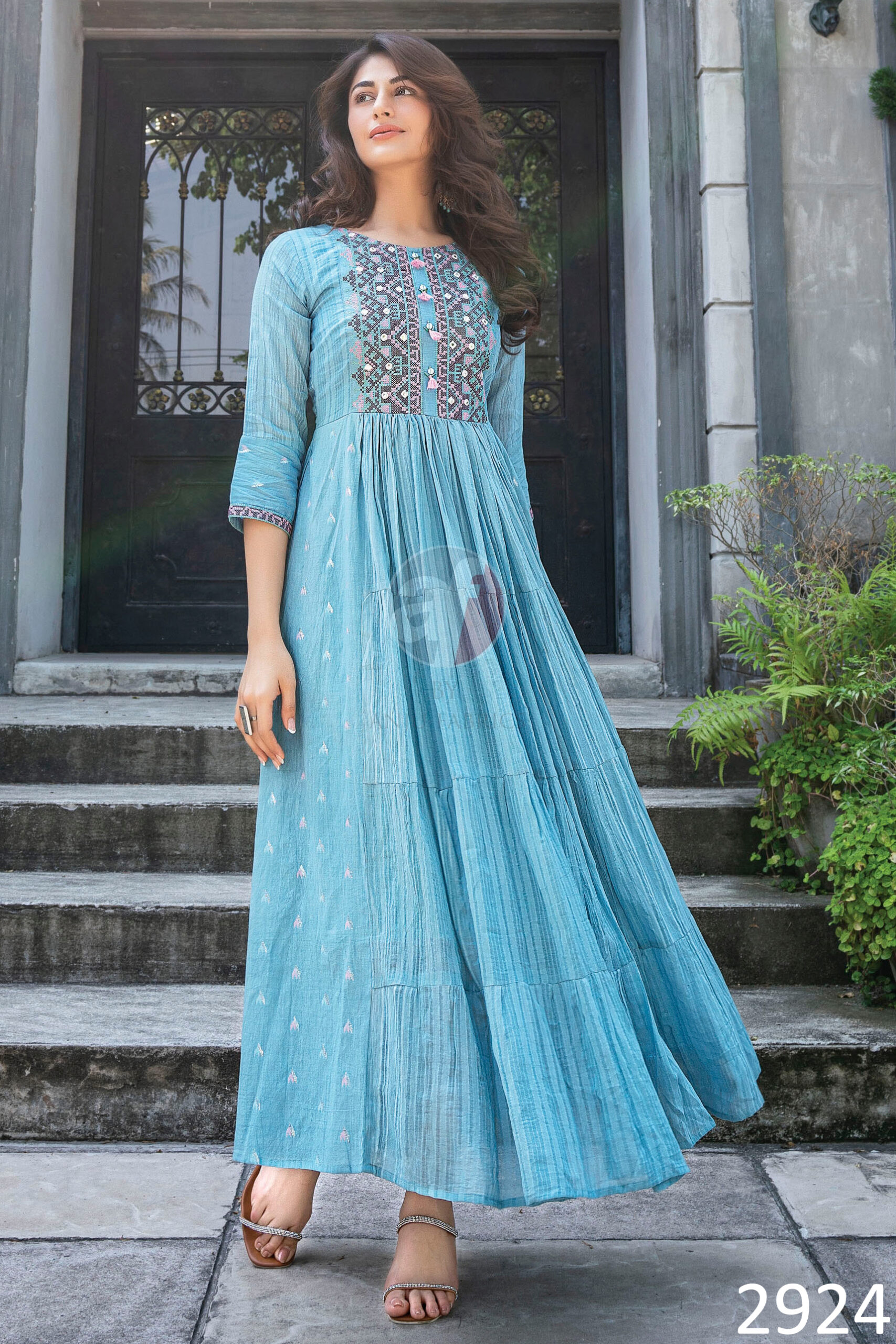 Flaunt The Magic Of Flared Gowns Mul Cotton Strips Cross Stitch Embroidery And Mirror Work With Twisted Dori With Tassels