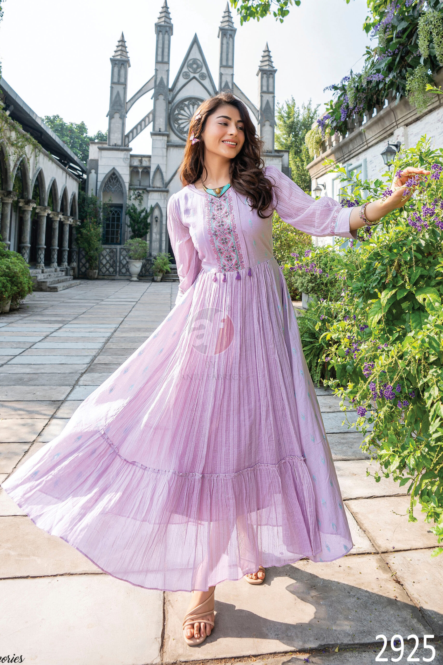 Flaunt The Magic Of Flared Gowns Mul Cotton Strips Cross Stitch Embroidery And Mirror Work With Twisted Dori With Tassels