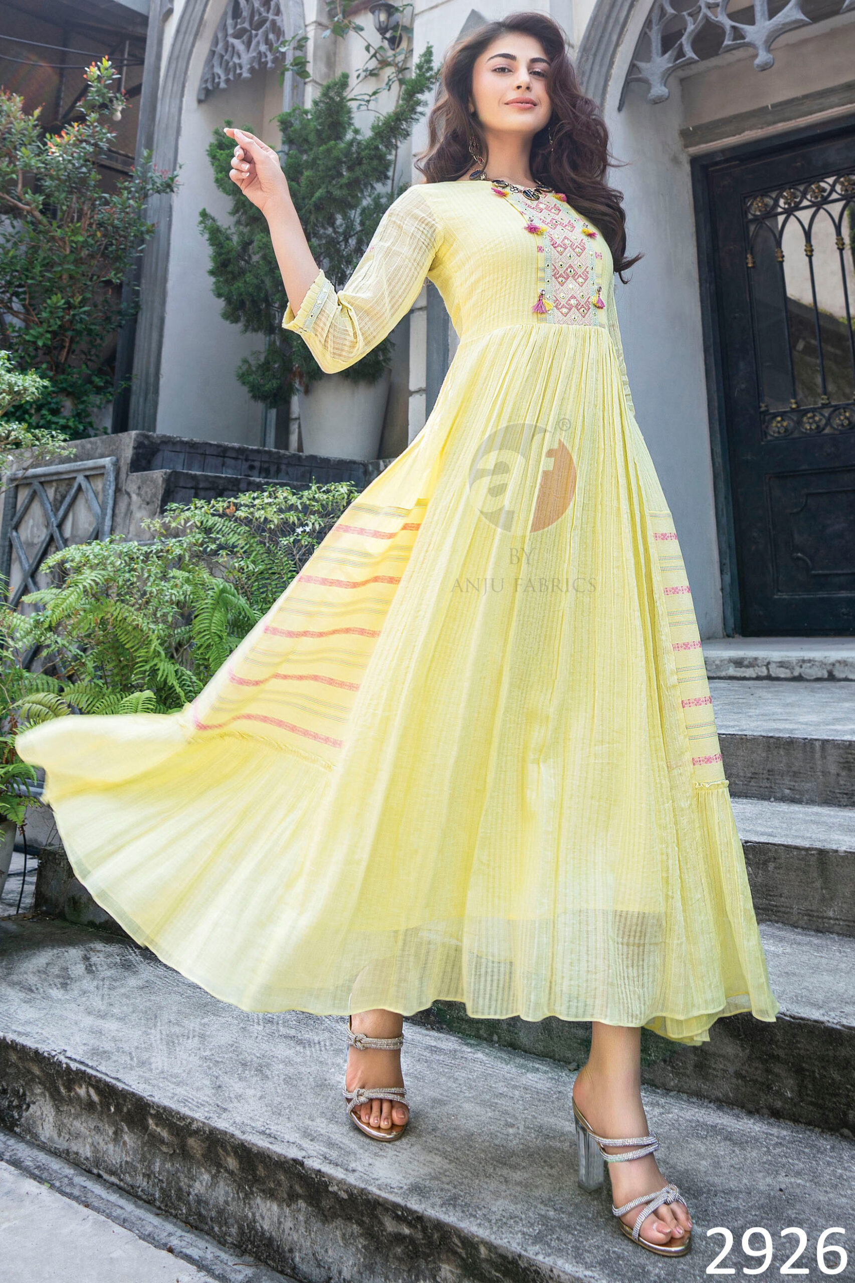 Flaunt The Magic Of Flared Gowns Mul Cotton Strips Cross Stitch Embroidery And Mirror Work With Twisted Dori With Tassels