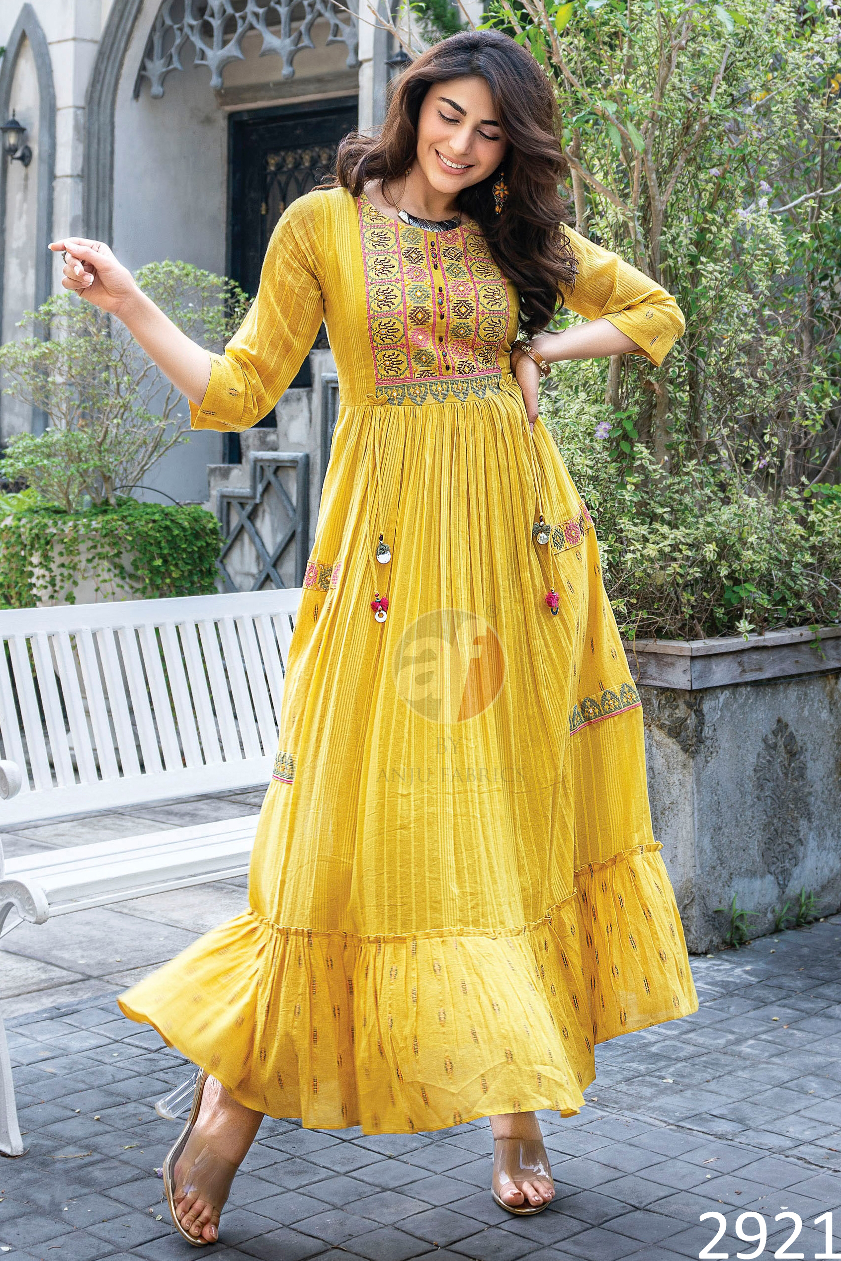 Flaunt The Magic Of Flared Gowns Mul Cotton Strips Cross Stitch Embroidery And Mirror Work With Twisted Dori With Tassels